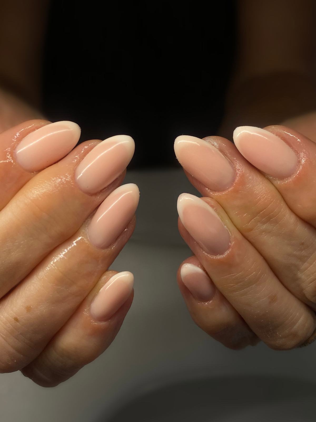 Glossy nude almond nails on both hands, natural nail prep
