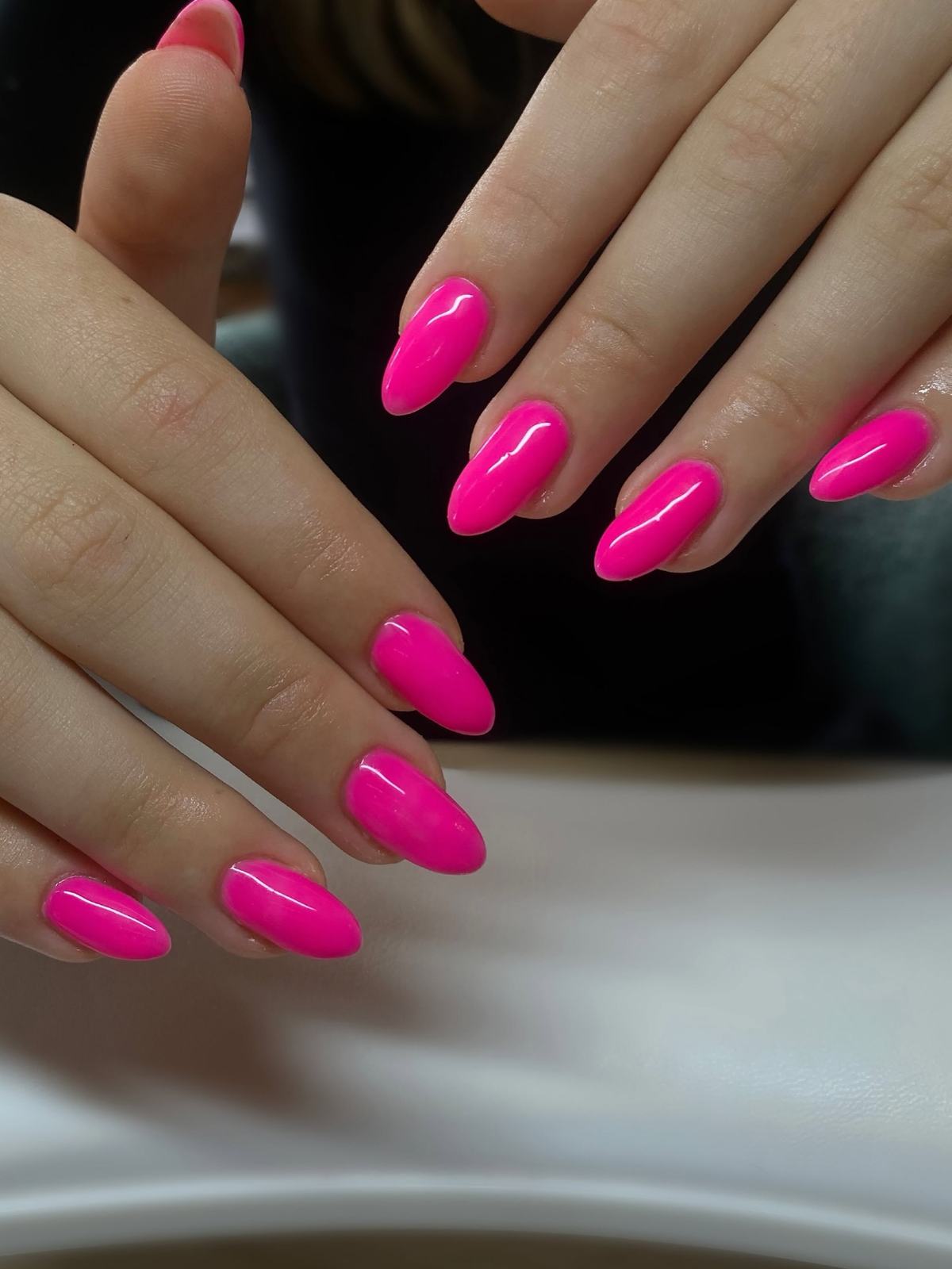 Bright neon-pink glossy almond nails